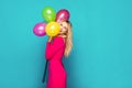 Blonde woman with balloons on blue Royalty Free Stock Photo