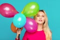 Blonde woman with balloons on blue Royalty Free Stock Photo