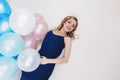 Blonde woman with balloons celebrates something