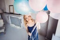 Blonde woman with balloons celebrates something