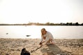 Blonde Woman On The Beach With Kitten Royalty Free Stock Photo