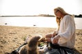 Blonde Woman On The Beach With Kitten Royalty Free Stock Photo