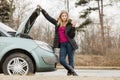 Blonde woman and broken down car on road Royalty Free Stock Photo