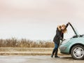 Blonde woman and broken down car on road Royalty Free Stock Photo