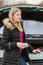 Blonde woman and broken down car on road Royalty Free Stock Photo