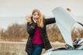 Blonde woman and broken down car on road Royalty Free Stock Photo