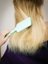 Blonde woman brushing hair back view Royalty Free Stock Photo