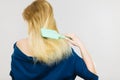 Blonde woman brushing hair back view Royalty Free Stock Photo