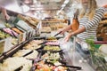 Blonde woman buying pasta prepared meal Royalty Free Stock Photo