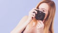 Blonde woman with camera on blue