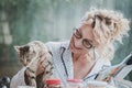 Blonde woman with a cat at breakfast time. Royalty Free Stock Photo