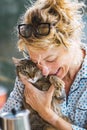 Blonde woman with a cat at breakfast time. Royalty Free Stock Photo