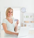 Blonde woman with credit card and notebook Royalty Free Stock Photo