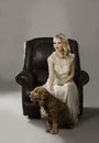 BLonde woman with cute dog at her feet Royalty Free Stock Photo