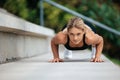 Blonde woman doing push ups outdoor. Royalty Free Stock Photo