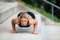 Blonde woman doing push ups outdoor. Royalty Free Stock Photo