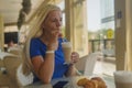 Blonde woman drink coffee in a coffee shop and be sad Royalty Free Stock Photo