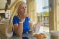 blonde woman drink coffee in a coffee shop and be sad Royalty Free Stock Photo