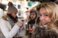 Blonde Woman drink warm mullet wine on the Christmas Market Royalty Free Stock Photo