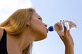 Blonde woman drinking bottled water