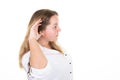 Blonde woman earing holding hand near ear trying to listen interesting news expressing communication concept in white background Royalty Free Stock Photo