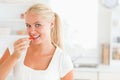 Blonde woman eating a slice of pepper Royalty Free Stock Photo