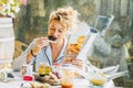 Blonde woman eating a toast at breakfast time. Royalty Free Stock Photo