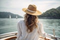 blonde woman with hat sits on a yacht and enjoys the summer holiday over the tropical ocean, AI Generated Royalty Free Stock Photo