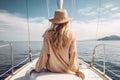 blonde woman with hat sits on a yacht and enjoys the summer holiday over the tropical ocean, AI Generated Royalty Free Stock Photo