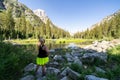 Blonde woman hiker points ot a mountain peak in the distance, in Grand Teton National Park. Royalty Free Stock Photo