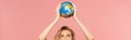 Blonde woman holding globe above head Royalty Free Stock Photo