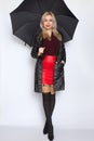Blonde woman holding open umbrella in her hands Royalty Free Stock Photo