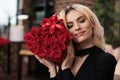 Blonde woman holding red roses close up, valentines day Royalty Free Stock Photo