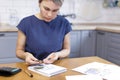 A blonde woman holds coins in her hands, counts money Royalty Free Stock Photo