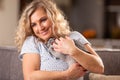 Blonde woman hugging a grey bunny in an emotional moment of love towards animals