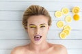 Blonde woman laying next to slices of lemon Royalty Free Stock Photo