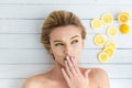 Blonde woman laying next to slices of lemon Royalty Free Stock Photo