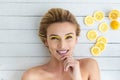 Blonde woman laying next to slices of lemon Royalty Free Stock Photo