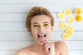 Blonde woman laying next to slices of lemon Royalty Free Stock Photo