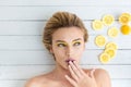 Blonde woman laying next to slices of lemon Royalty Free Stock Photo