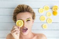 Blonde woman laying next to slices of lemon Royalty Free Stock Photo