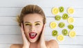 Blonde woman laying next to slices of lemon and kiwi Royalty Free Stock Photo