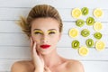 Blonde woman laying next to slices of lemon and kiwi Royalty Free Stock Photo