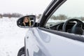 Blonde woman looking in the car rear-view mirror and smiling Royalty Free Stock Photo