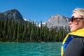 Blonde woman looks out in the distance, thinking and reflecting while canoeing on Emerald Lake in Yoho National Park Canada Royalty Free Stock Photo