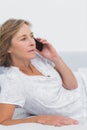 Blonde woman lying on bed making a phone call Royalty Free Stock Photo