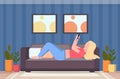 Blonde woman lying on couch girl taking selfie photo on smartphone camera modern living room interior female cartoon Royalty Free Stock Photo