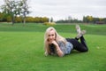 Blonde woman is lying on the golf field Royalty Free Stock Photo