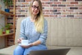 Blonde woman make online shopping and drinking coffee Royalty Free Stock Photo