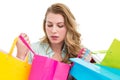 Blonde woman opening gift bag and looking on it Royalty Free Stock Photo